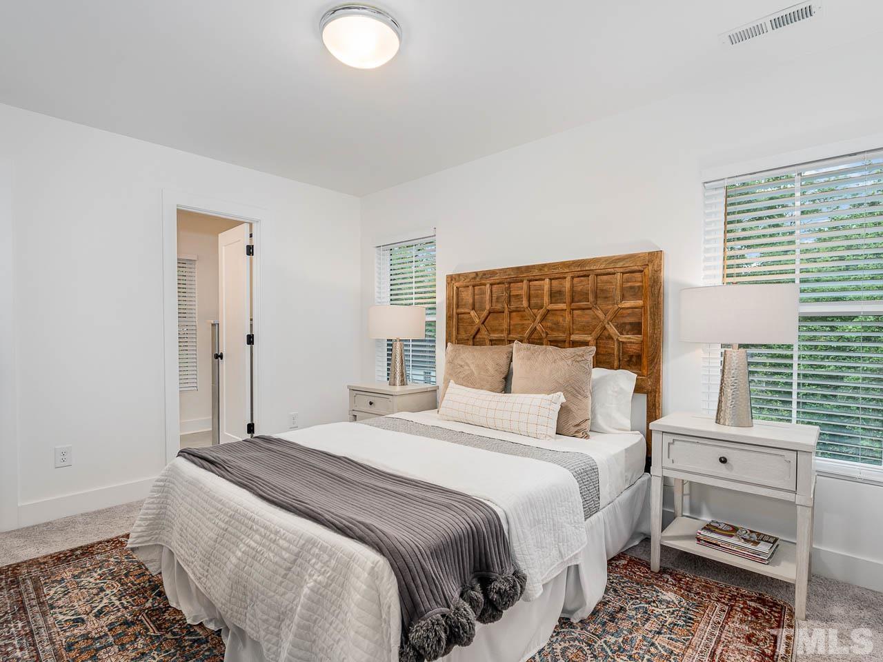 614 East Ellerbee Street Durham, NC 27704 - Photo 18 of 28 a bedroom with a bed and a window