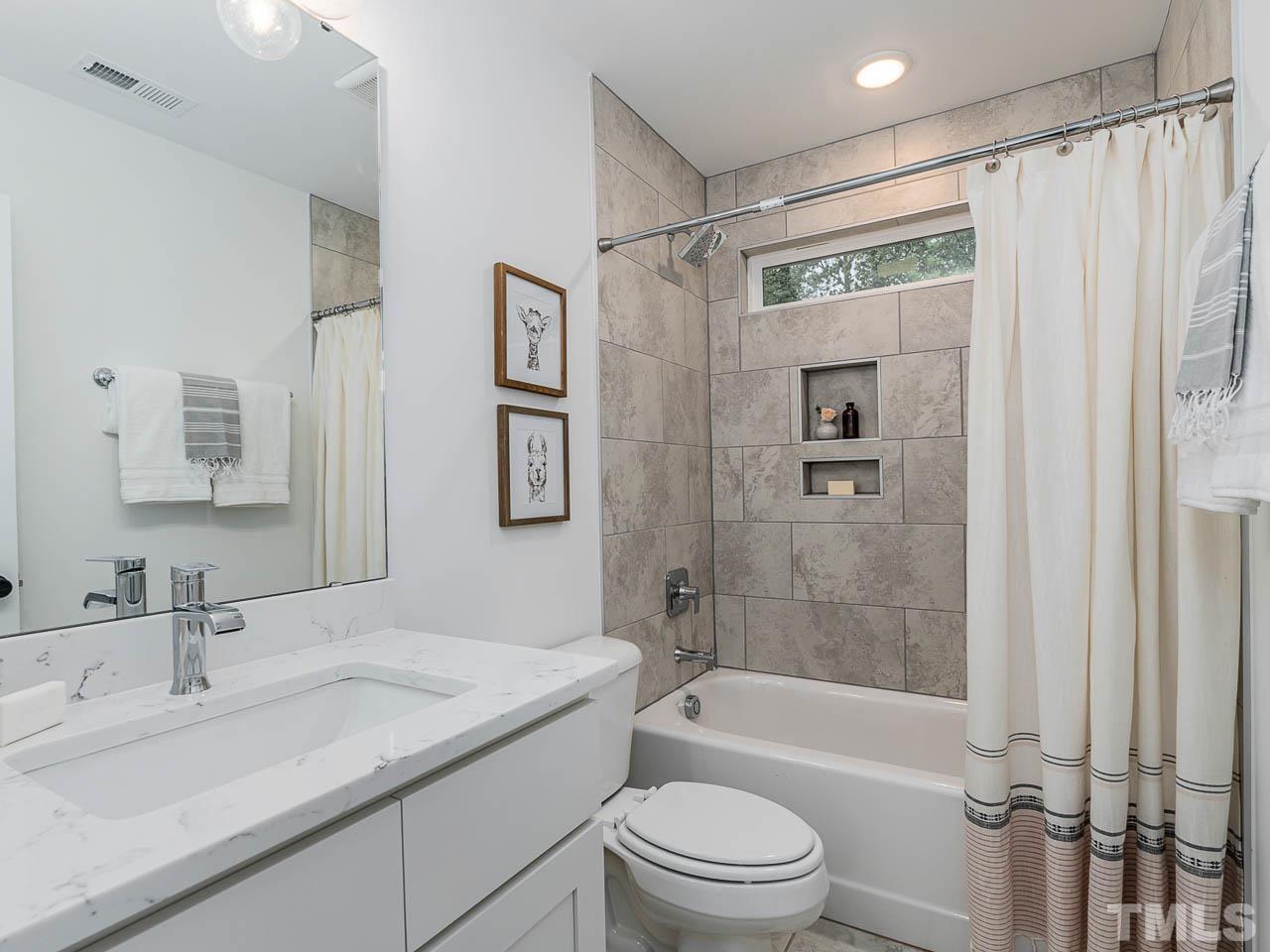 614 East Ellerbee Street Durham, NC 27704 - Photo 20 of 28 a bathroom with a granite countertop sink toilet and shower