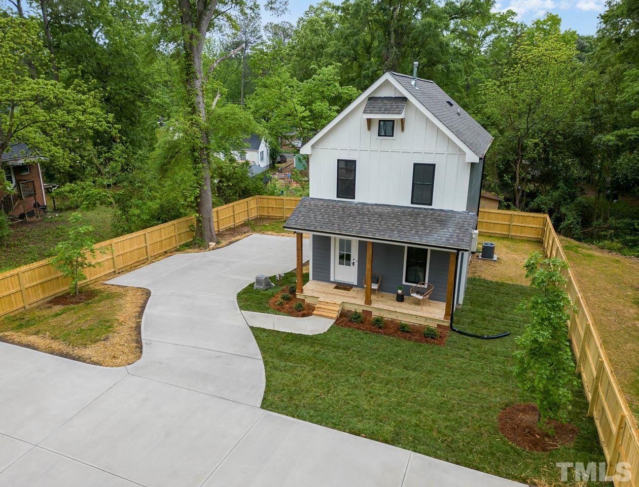 614 East Ellerbee Street Durham, NC 27704 - Photo 5 of 28 a front view of a house with a yard table and chairs