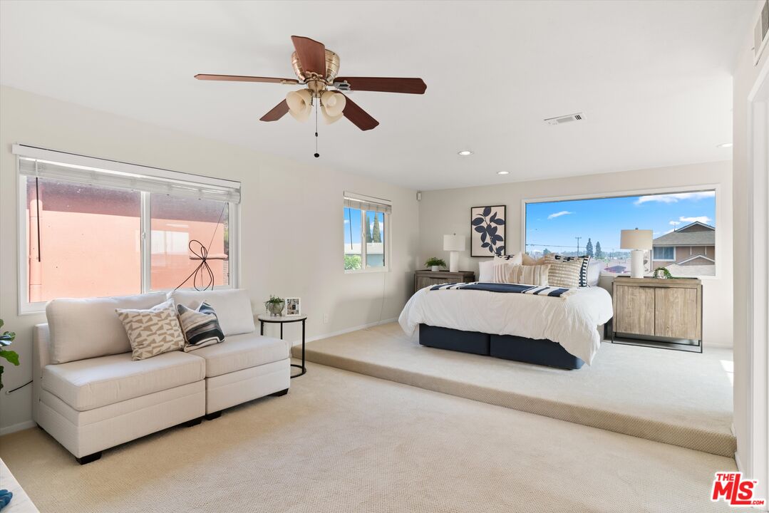 1407 East Kramer Drive Carson, CA 90746 - Photo 13 of 24 a spacious bedroom with a bed couches and window