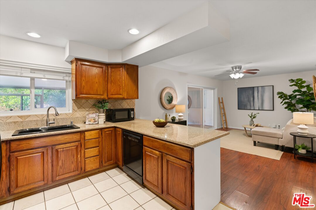 1407 East Kramer Drive Carson, CA 90746 - Photo 7 of 24 a kitchen with a sink stove and cabinets