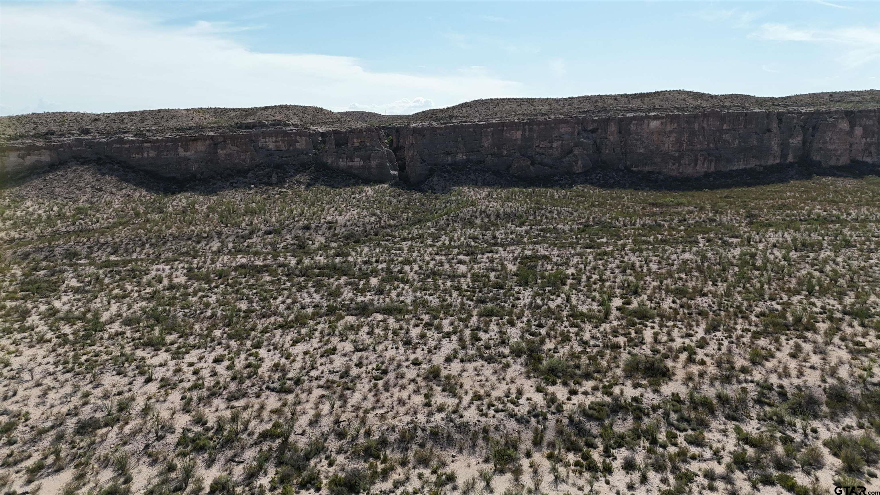 26885 Long Draw Terlingua, TX 79852 - Photo 6 of 28 a view of a dry yard with wooden fence
