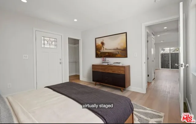 a bedroom with a bed and a flat screen tv