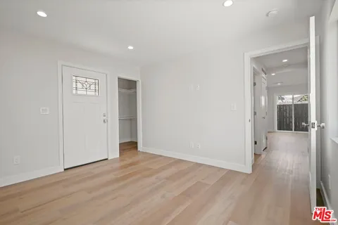 a view of a hallway with wooden floor