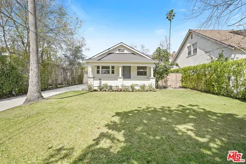 a front view of a house with a yard outdoor seating and garage