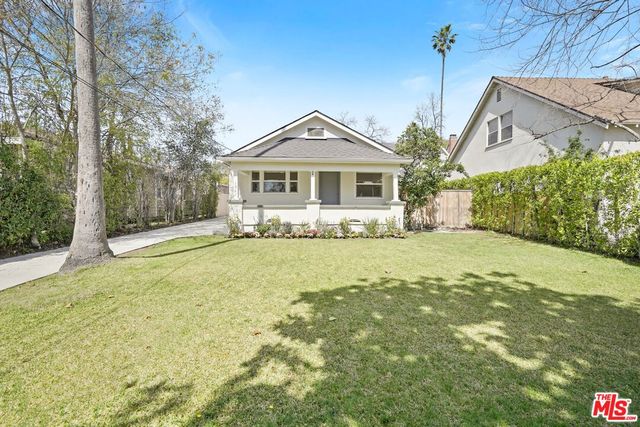 a front view of a house with a yard outdoor seating and garage
