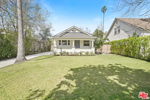 a front view of a house with a yard outdoor seating and garage