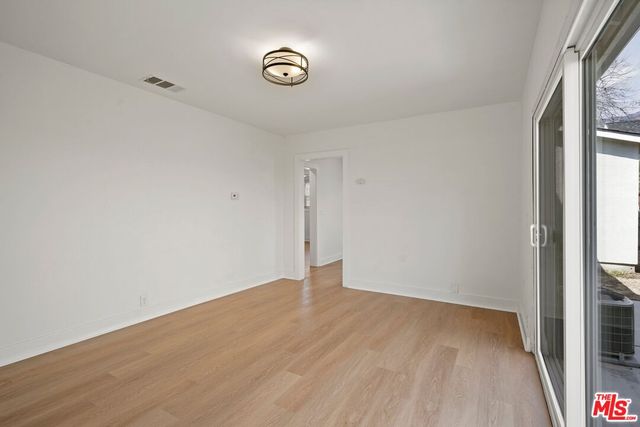 a view of a room with wooden floor and windows