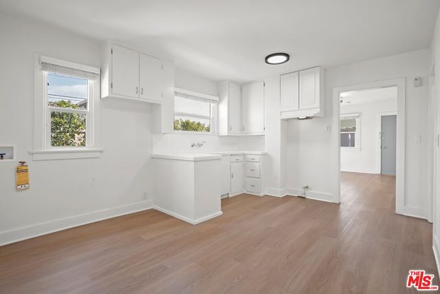 a room with a white cabinets and wooden floor
