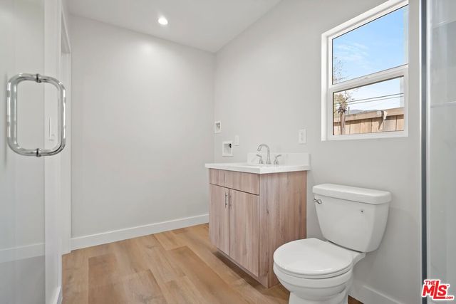 a bathroom with a toilet sink and a mirror