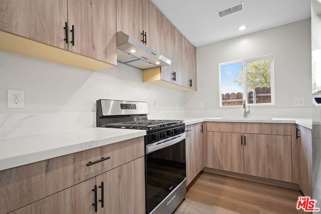 a kitchen with stainless steel appliances a sink and a stove