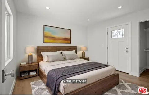 a bedroom with a bed and a painting on the wall