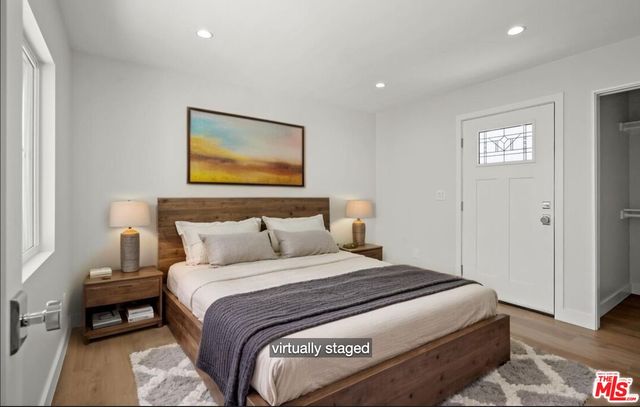 a bedroom with a bed and a painting on the wall