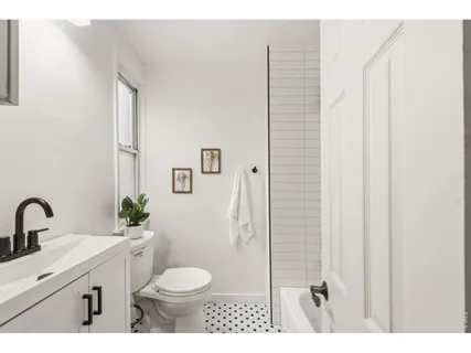 a bathroom with a toilet sink and shower