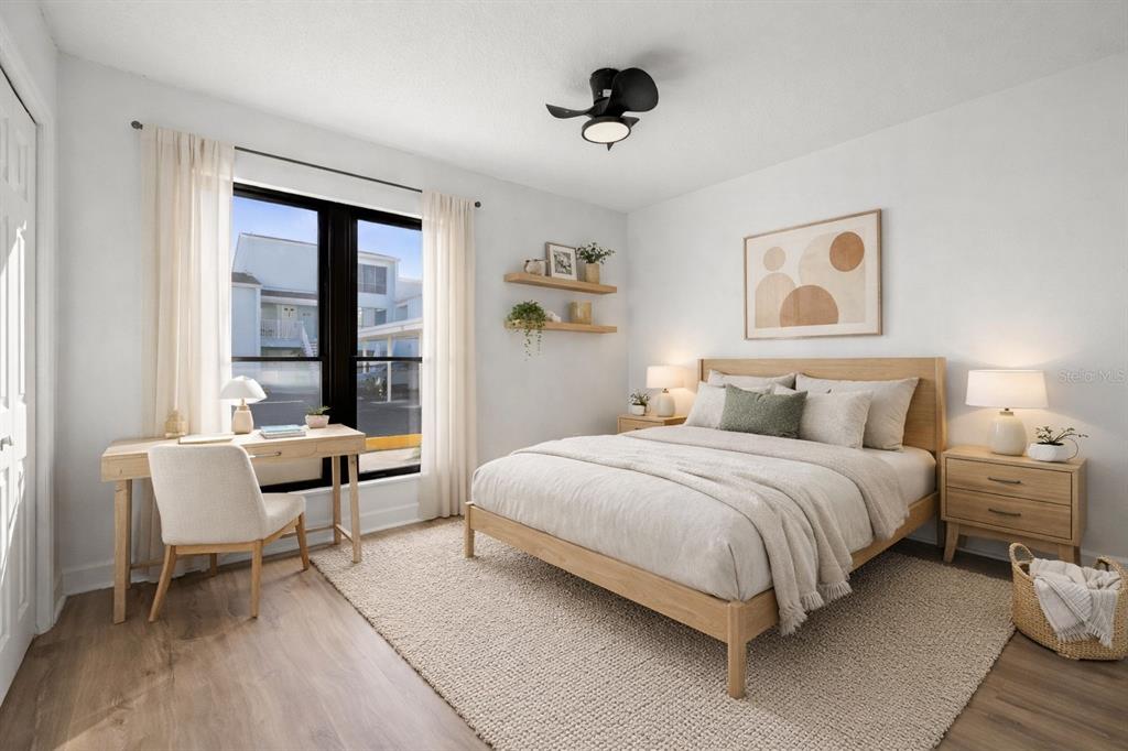 1 Windrush Boulevard, Unit 19 Indian Rocks Beach, FL 33785 - Photo 20 of 52 a bedroom with a bed and a window