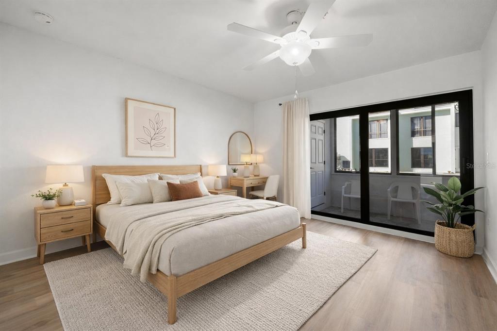 1 Windrush Boulevard, Unit 19 Indian Rocks Beach, FL 33785 - Photo 25 of 52 a bedroom with a large bed and a chandelier