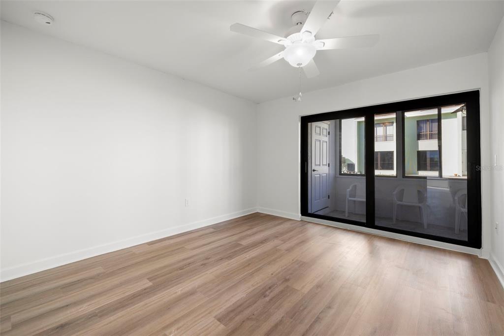 1 Windrush Boulevard, Unit 19 Indian Rocks Beach, FL 33785 - Photo 26 of 52 wooden floor in an empty room with a window