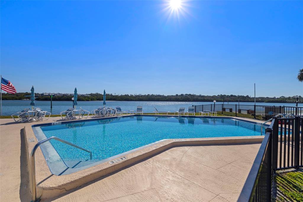 1 Windrush Boulevard, Unit 19 Indian Rocks Beach, FL 33785 - Photo 38 of 52 a view of a swimming pool and city from a terrace
