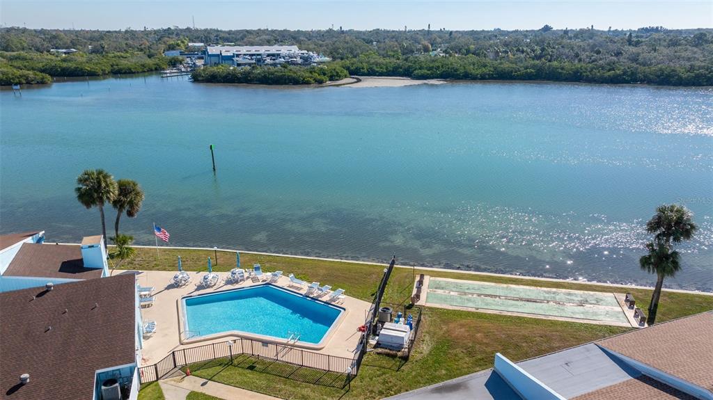 1 Windrush Boulevard, Unit 19 Indian Rocks Beach, FL 33785 - Photo 40 of 52 a view of a swimming pool with a lake view