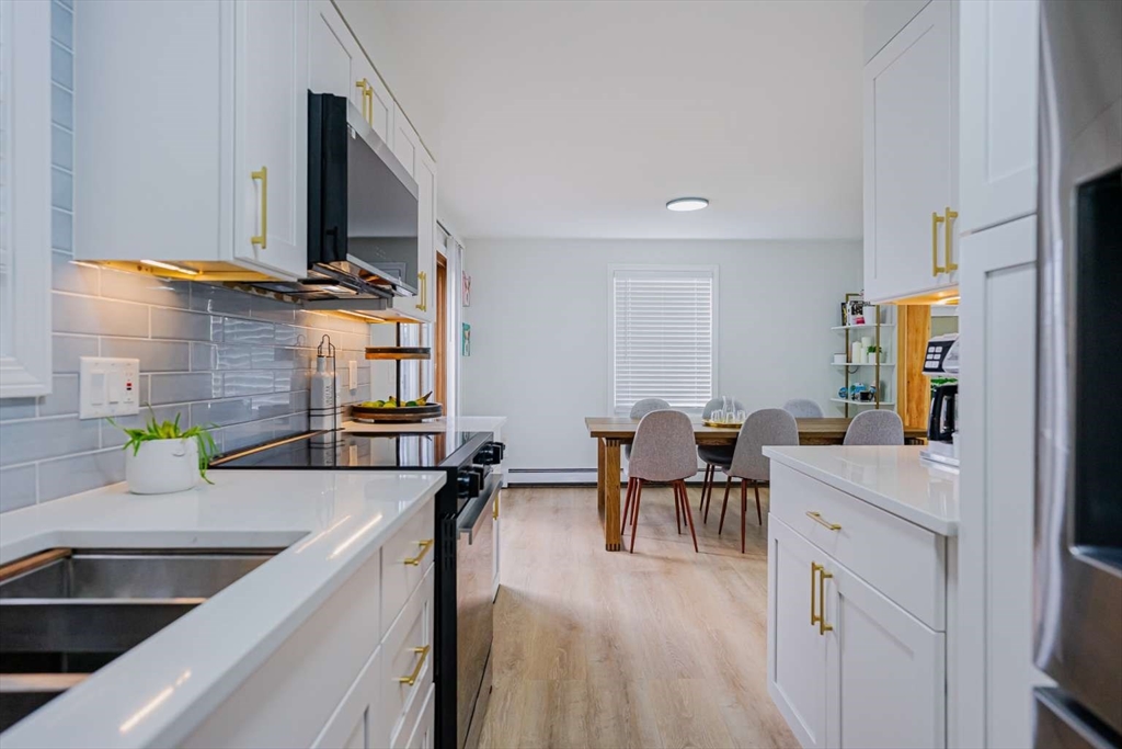 27 Silver Road, Unit 27 Everett, MA 02149 - Photo 1 of 42 a kitchen with stainless steel appliances a sink stove and table chair