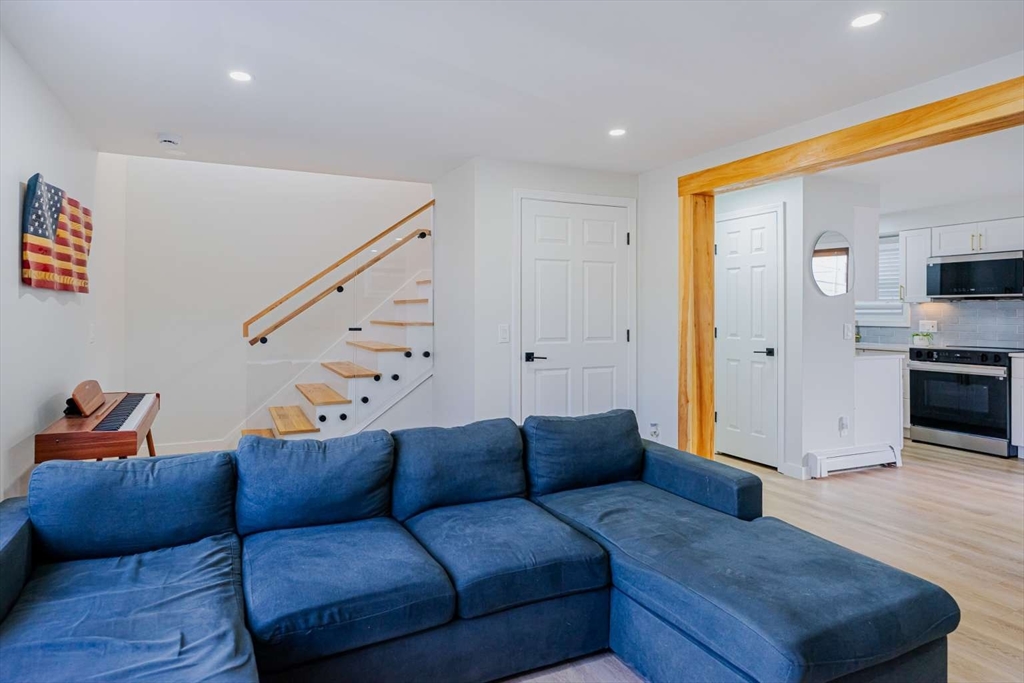 27 Silver Road, Unit 27 Everett, MA 02149 - Photo 18 of 42 a living room with furniture and a flat screen tv