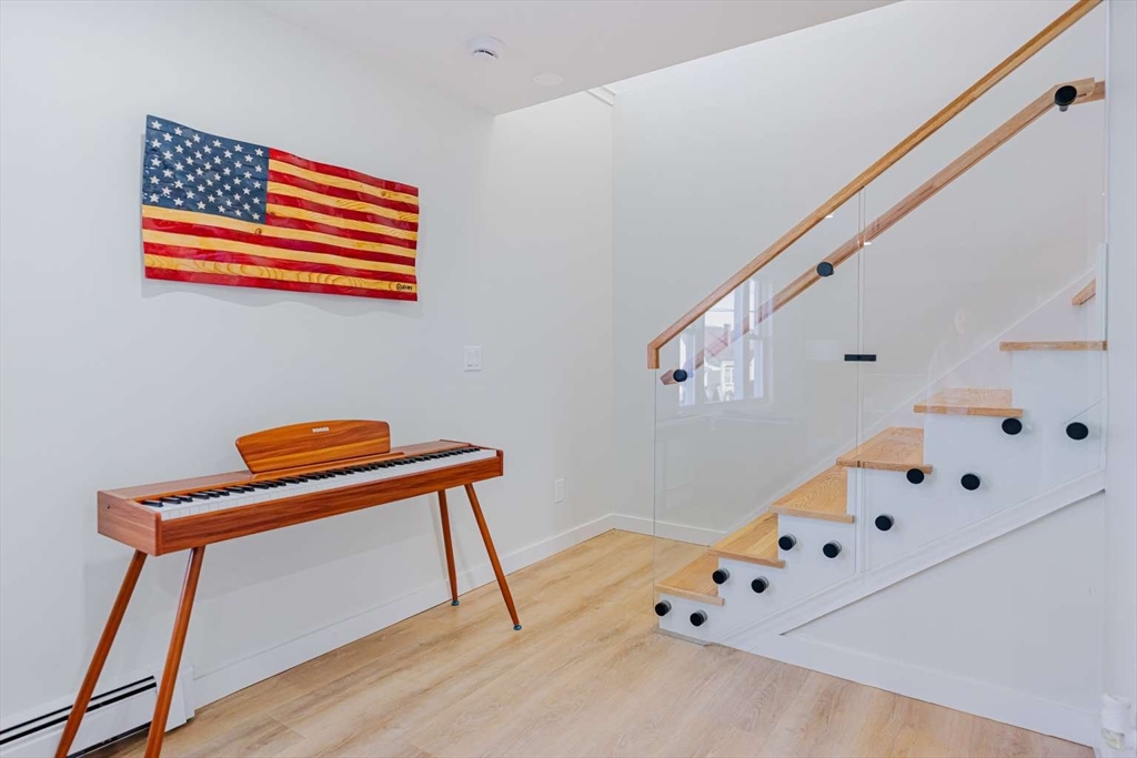 27 Silver Road, Unit 27 Everett, MA 02149 - Photo 19 of 42 a room with furniture and wooden floor