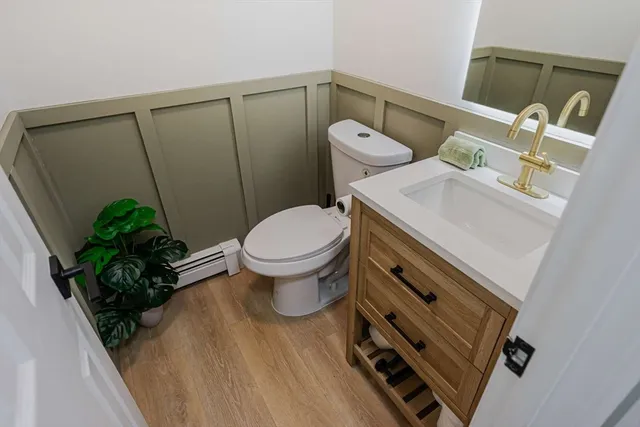 a bathroom with a toilet sink and mirror