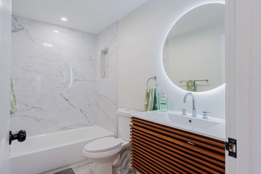 27 Silver Road, Unit 27 Everett, MA 02149 - Photo 27 of 42 a bathroom with a sink a toilet and a mirror