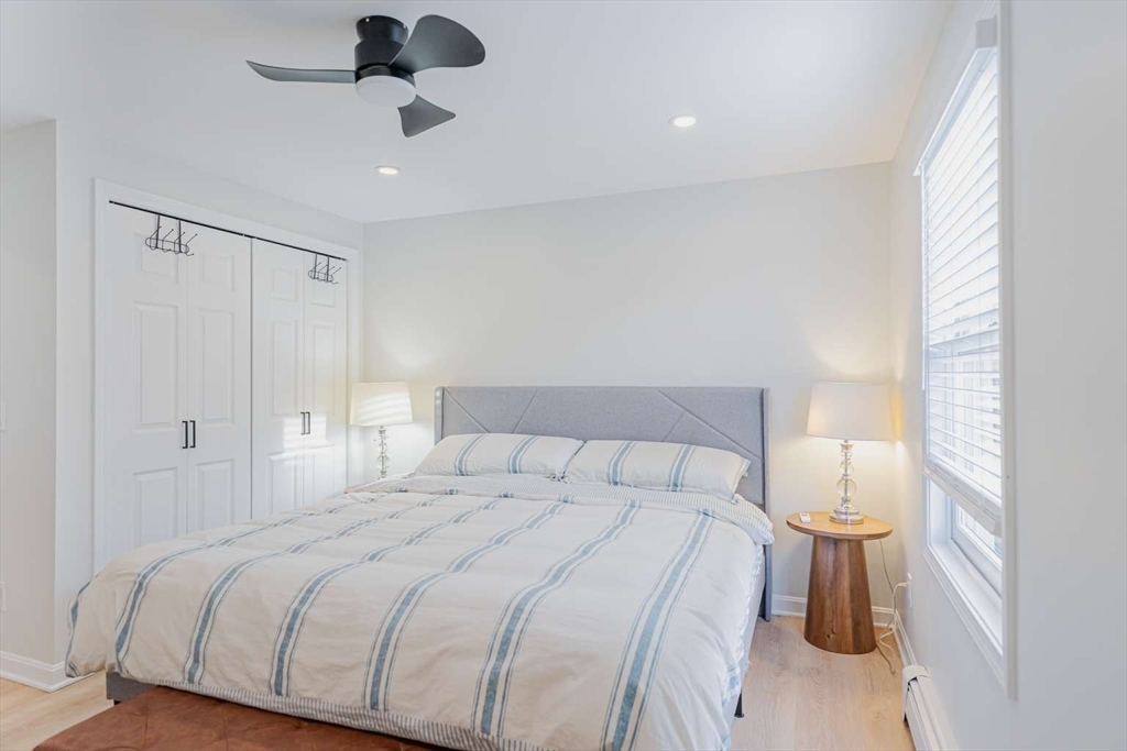 27 Silver Road, Unit 27 Everett, MA 02149 - Photo 29 of 42 a bedroom with a bed and a chandelier