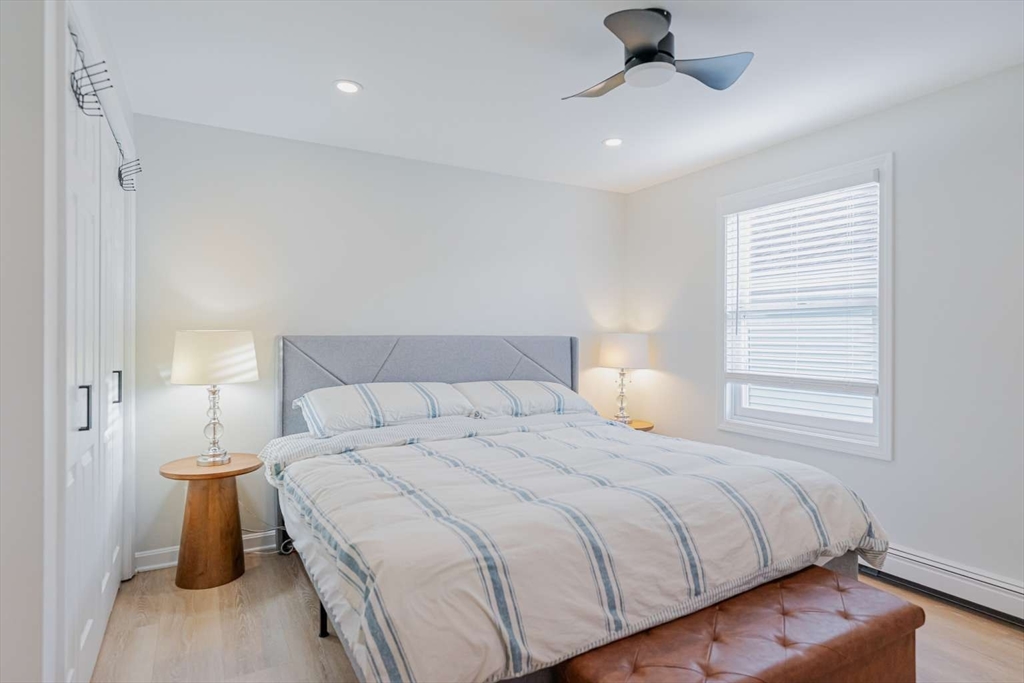 27 Silver Road, Unit 27 Everett, MA 02149 - Photo 30 of 42 a bedroom with a bed and a chandelier