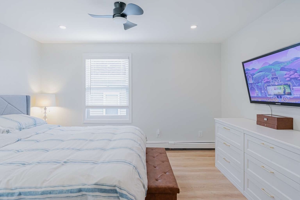 27 Silver Road, Unit 27 Everett, MA 02149 - Photo 31 of 42 a bedroom with a bed and a lamp on dresser
