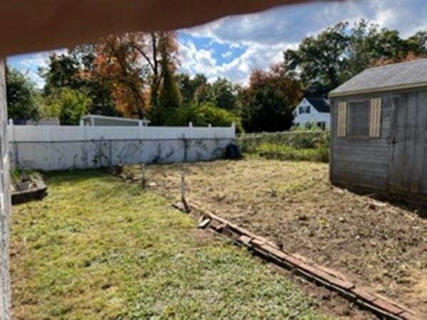 23 Edgewood Road Billerica, MA 01821 - Photo 12 of 40 a view of a backyard with a fence