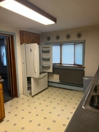 23 Edgewood Road Billerica, MA 01821 - Photo 27 of 40 a bedroom with a bed and a refrigerator