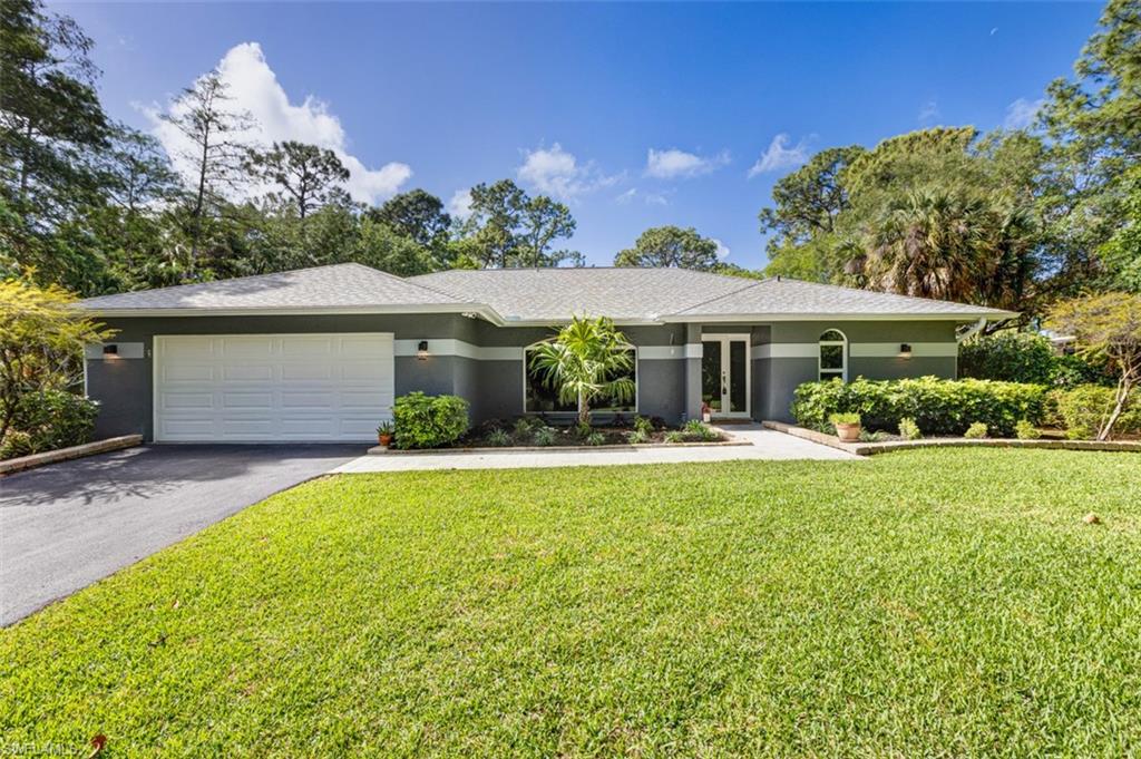 4710 15th Avenue Southwest Naples, FL 34116 - Photo 2 of 49 a front view of a house with garden