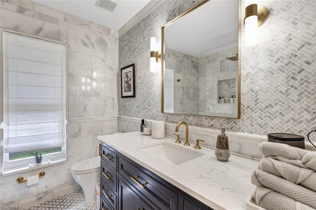 4710 15th Avenue Southwest Naples, FL 34116 - Photo 34 of 49 a bathroom with a granite countertop sink and a mirror