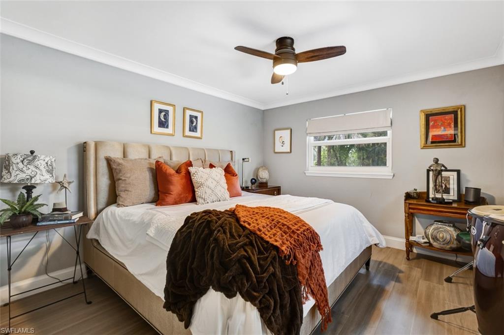 4710 15th Avenue Southwest Naples, FL 34116 - Photo 37 of 49 a bedroom with a bed and a chandelier