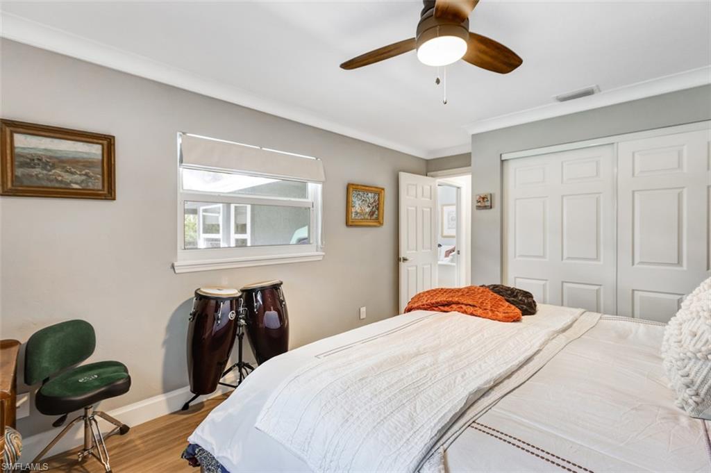 4710 15th Avenue Southwest Naples, FL 34116 - Photo 38 of 49 a bedroom with a bed and a chandelier