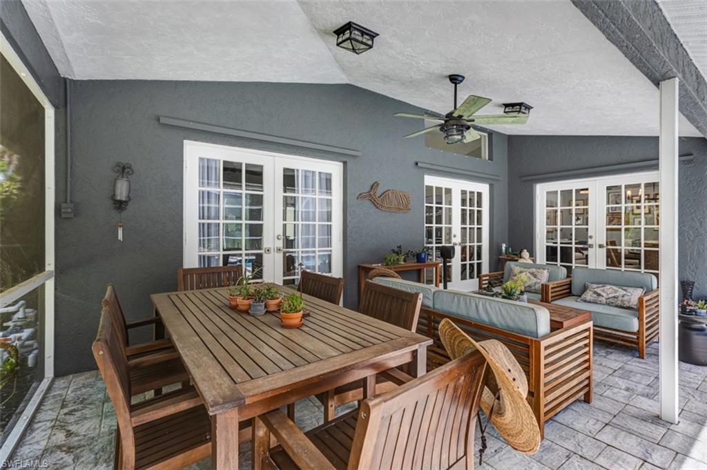 4710 15th Avenue Southwest Naples, FL 34116 - Photo 5 of 49 a living room with furniture a chandelier and a table
