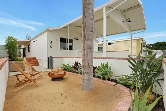 a building outdoor space with patio furniture and potted plants