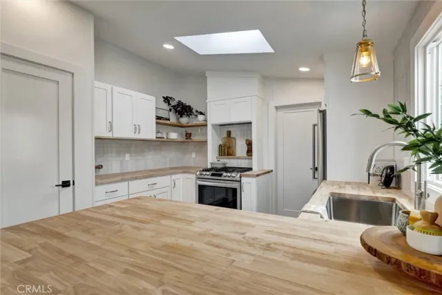 a kitchen with a refrigerator stove and sink