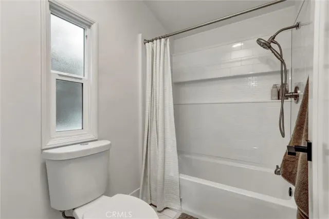 a bathroom with a shower and a toilet