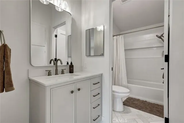 a bathroom with a double vanity sink toilet and shower