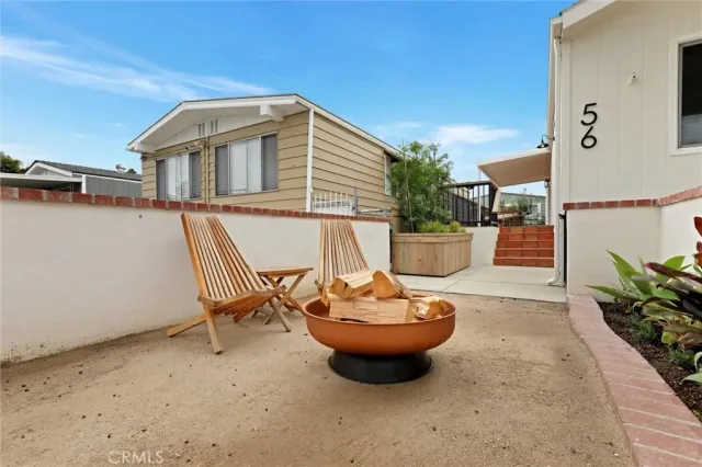 a view of a patio with table and chairs potted plants