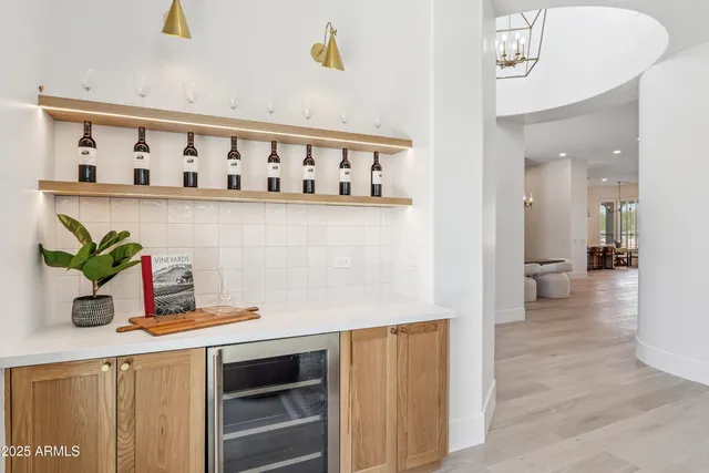 a living room with furniture and a view of kitchen
