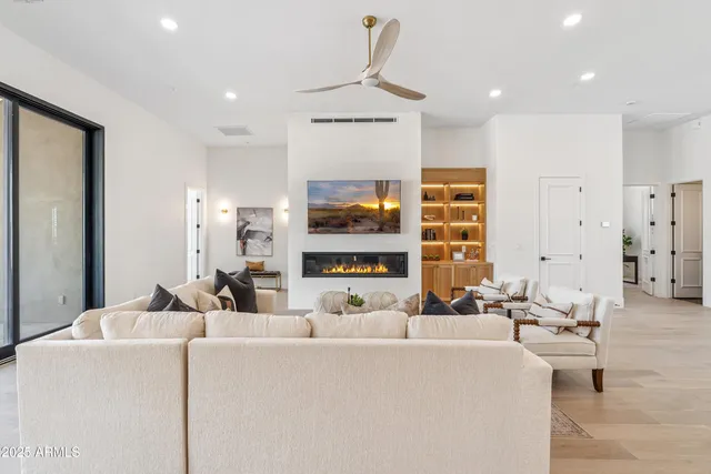 a spacious bedroom with a bed couch and a potted plant