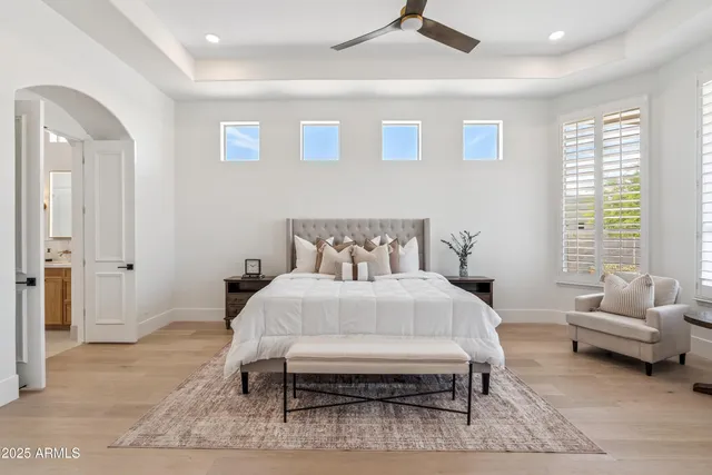a bedroom with a large bed and a large window