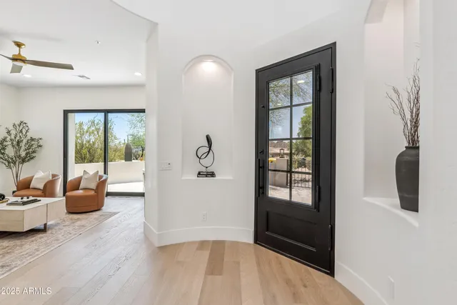 a living room with furniture and a floor to ceiling window