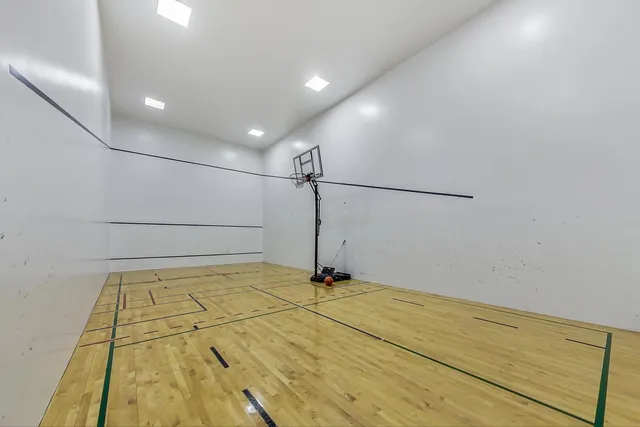 a view of a kitchen with kitchen island a counter top space a sink and stainless steel appliances