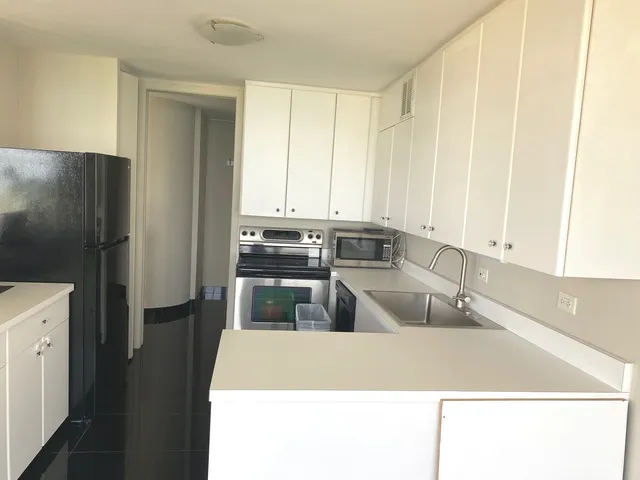 an empty room with a fireplace and windows