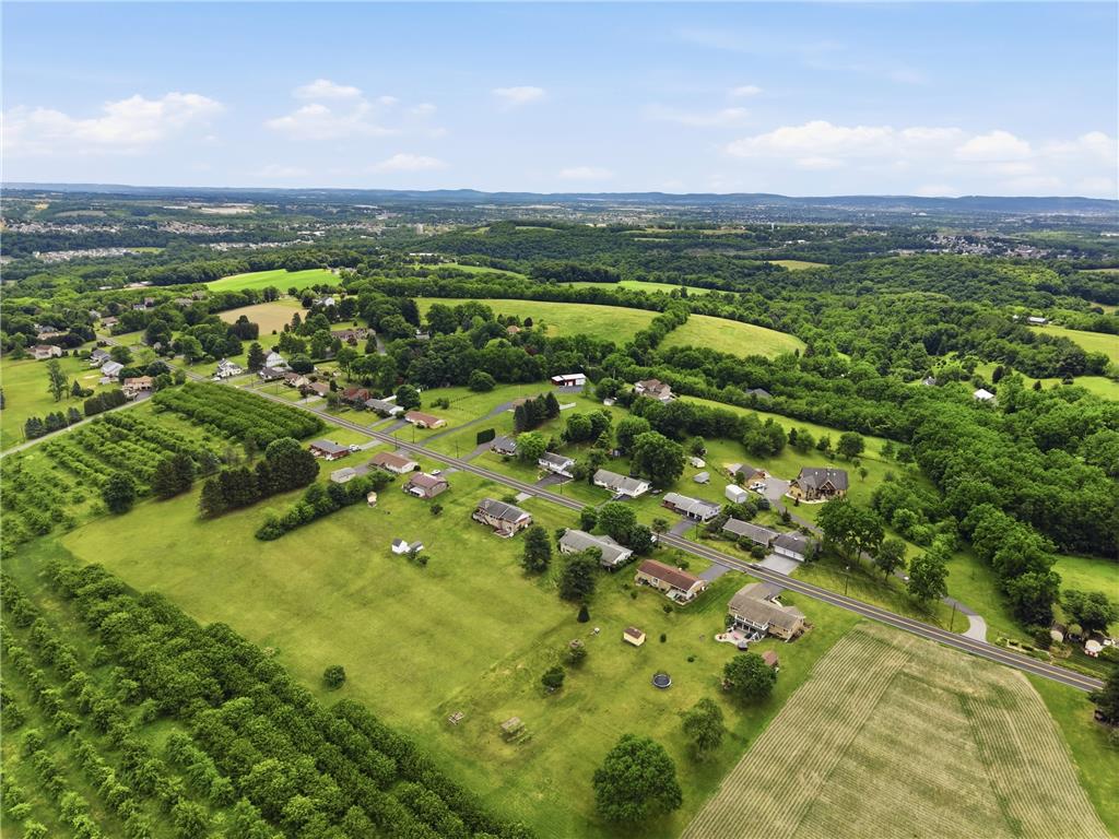 1657 Clearview Road Coplay, PA 18037 - Photo 76 of 77 An aerial perspective reveals a serene community nestled amidst verdant fields and wooded landscapes.